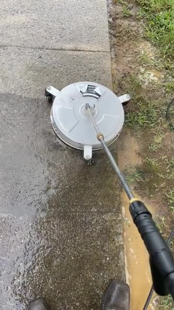 Surface cleaner at work on a concrete walkway